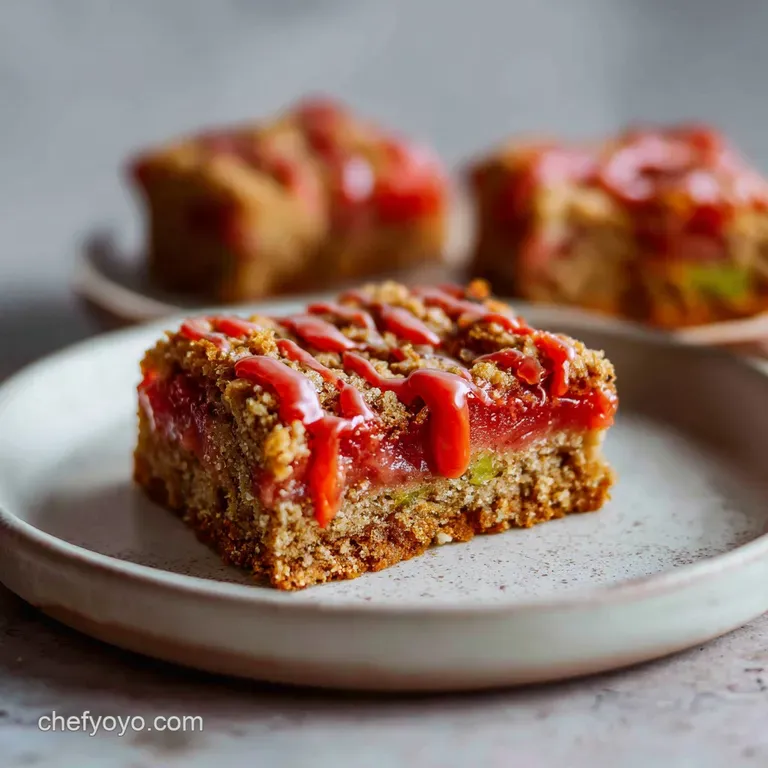 Guava bar with layered crust and guava filling, presented with a sprig of mint and a dusting of powdered sugar, appealing ...
