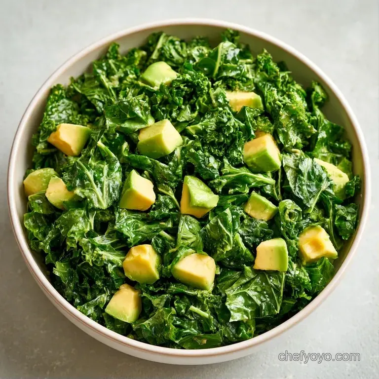 Vibrant green leafy greens and diced avocado artfully arranged in a shallow bowl with a drizzle of lemon vinaigrette.