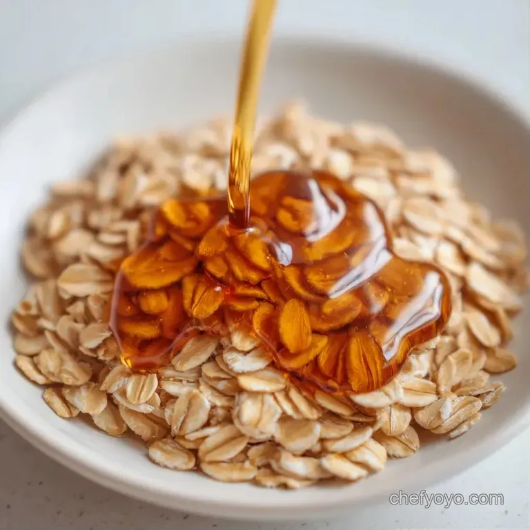 A minimalist white bowl of warm oats garnished with fresh berries and a swirl of shimmering maple glaze.
