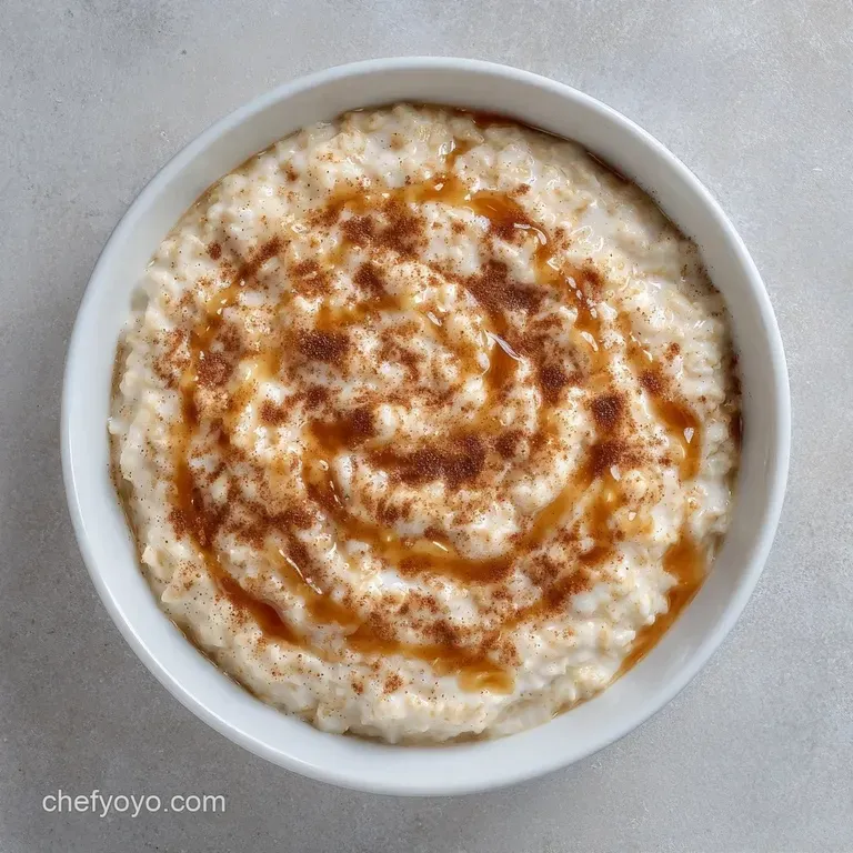 A minimalist white bowl of warm porridge garnished with fresh blueberries and toasted almond slivers on a linen cloth.